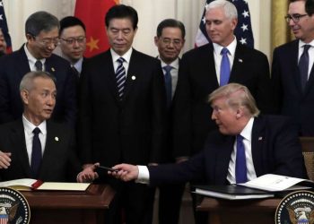 President Donald Trump signs a trade agreement with Chinese Vice Premier Liu He, in the East Room of the White House, Wednesday, Jan. 15, 2020, in Washington. (AP Photo/Evan Vucci)