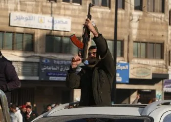 Miliziani "ribelli" a Homs festeggiano la presa di Damasco (Ansa)