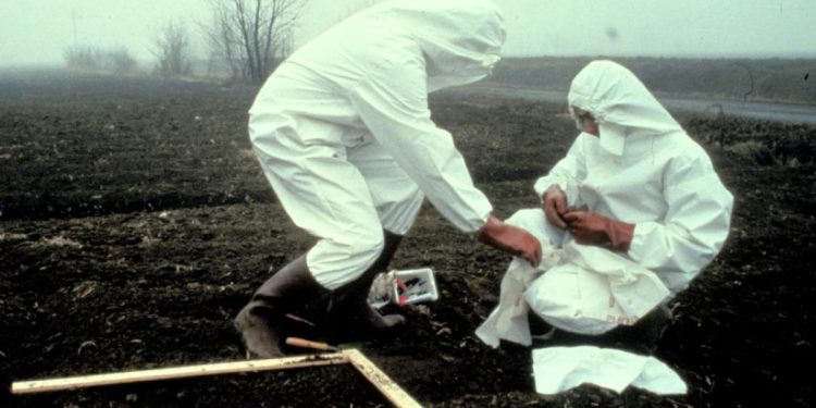 Due tecnici effettuano i prelievi di terreno per stabilire il grado di inquinamento dopo l'incidente all'Icmesa di Seveso (Ansa)